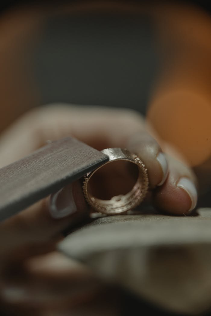 Crafting Captivating Headlines: Your awesome post title goes here Close-up of a jeweler polishing a gold ring, showcasing craftsmanship.